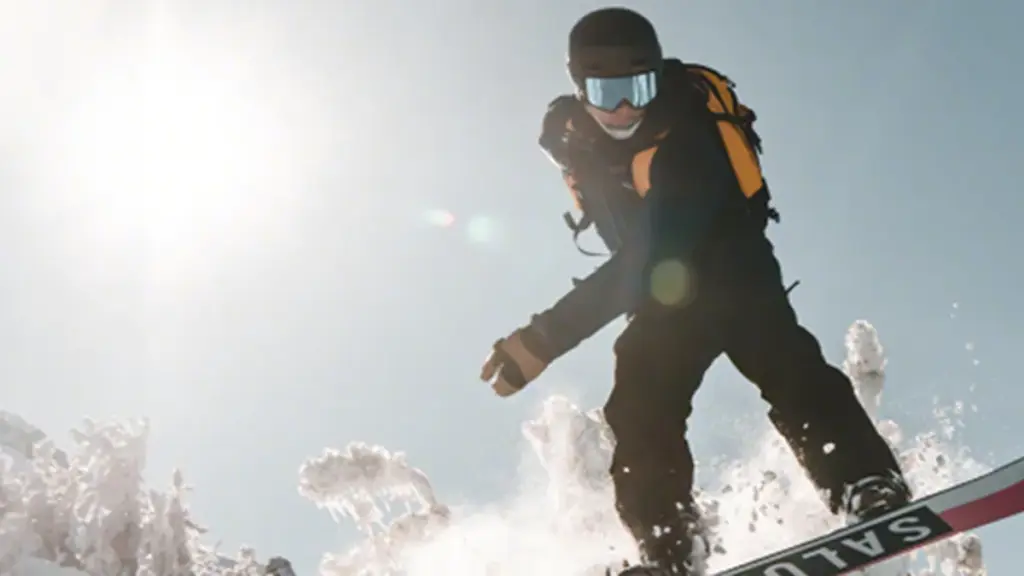 First-person view through ski goggles with a slightly fogged lens on a snowy slope